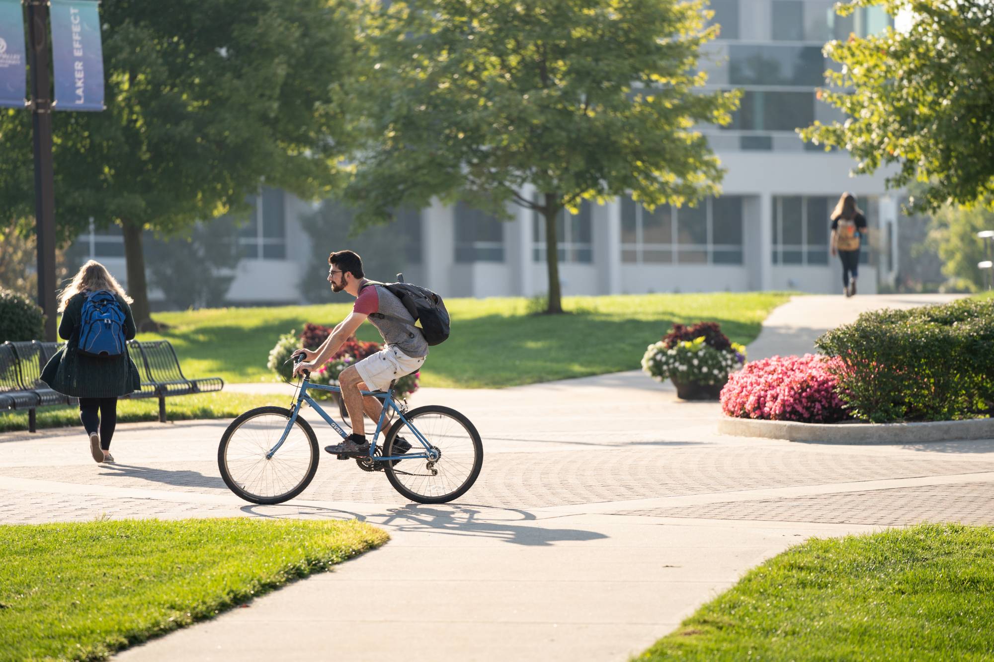 student bikes across campus